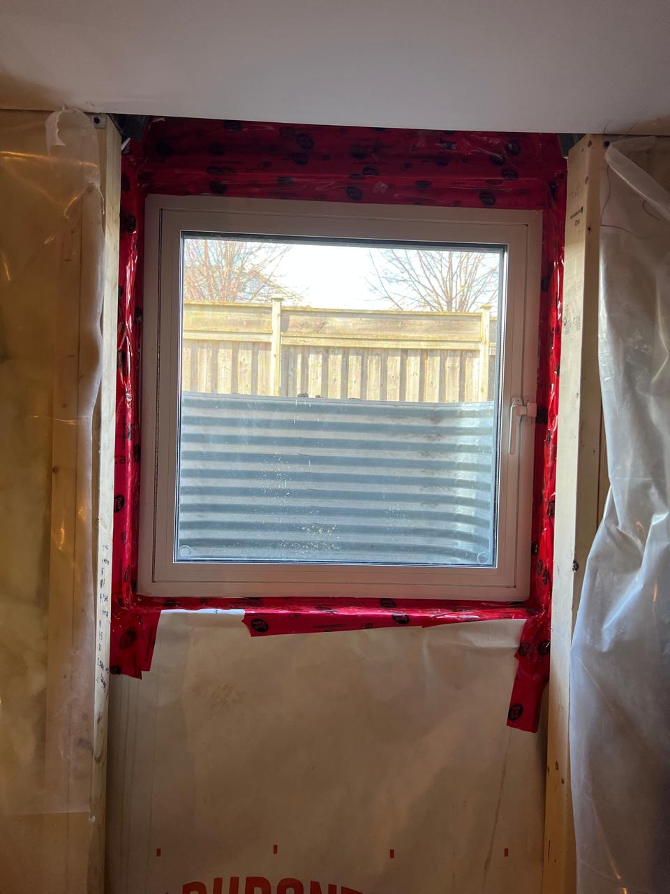 Egress window open from inside upgraded with black color on outside project by sv constructions and services inc.